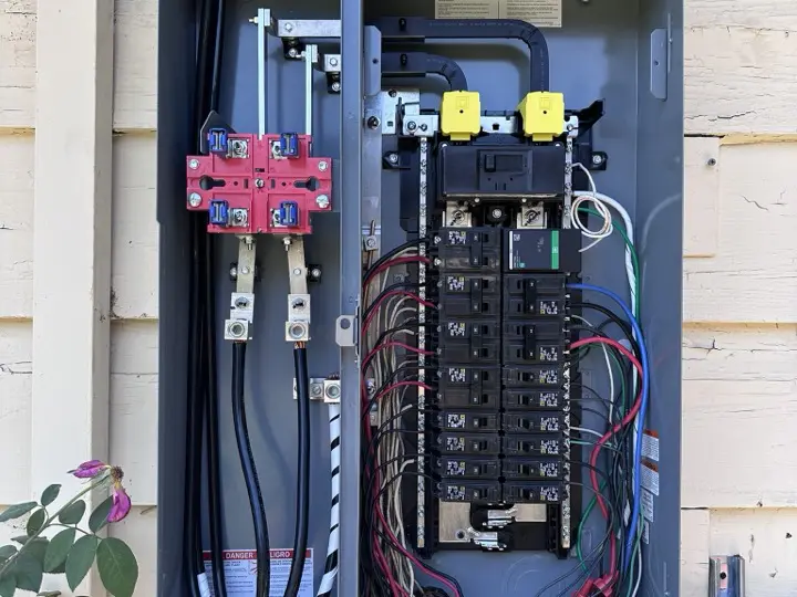 Service panel with the cover off and a level resting on the enclosure during a check