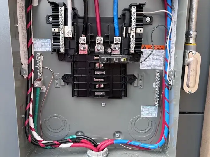 Open three-phase panel with breakers and labeled circuits