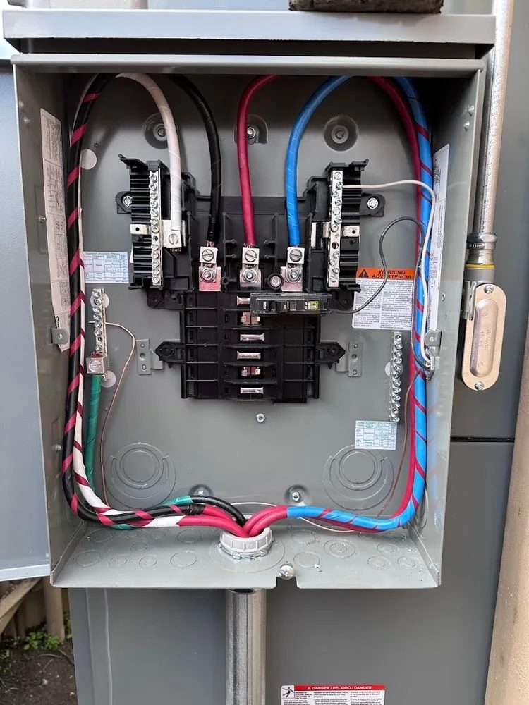 Open three-phase panel with breakers and labeled circuits